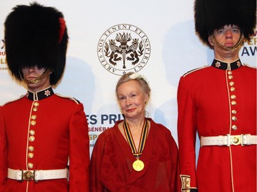 Actress and director Diana Leblanc poses on the red carpet with a pair of foot guards at the Governor General's Performing Arts Awards Gala held at the National Arts Centre on Saturday, May 30, 2015.
