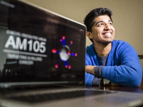 Aditya Mohan, 18, poses with a computer showing a graphic from his nationally-recognized science project that studies viruses that kill cancer cells. Mohan won a national science competition.