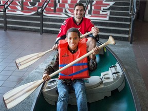 AJ Osman, 9, who attends Camp Smitty, and Ottawa Senators defenceman Cody Ceci try out a canoe following an announcement at Canadian Tire Centre on Wednesday morning that the Ottawa Senators Foundation is partnering with five organizations including the Tim Horton Children's Foundation and making donations of about $200,000 to underwrite the costs associated with hosting 5-12 day summer outdoor camp sessions.