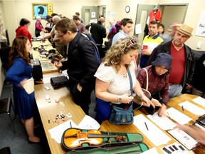 Bargain-hunters look through items at Saturday's OC Transpo Unclaimed Items Sale.