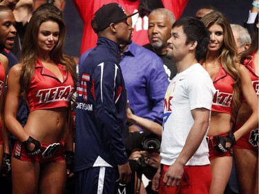 Floyd Mayweather (Center L) and Manny Pacquiao (Center R) face off following their weigh-in on May 1, 2015 in Las Vegas, Nevada one day before their "Fight of the Century" on May 2 at the MGM Grand Garden Arena.