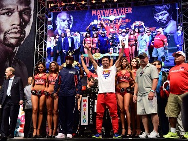 Manny Pacquiao and Floyd Mayweather pose on stage following their weigh-in on May 1, 2015 in Las Vegas, Nevada one day before their "Fight of the Century" on May 2 at the MGM Grand Garden Arena.