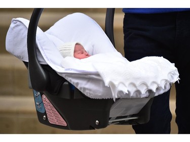 Britain's Prince William, Duke of Cambridge, carries his newly-born daughter, his second child with Catherine, Duchess of Cambridge, as they leave the Lindo Wing at St Mary's Hospital in central London, on May 2, 2015.  The Duchess of Cambridge was safely delivered of a daughter weighing 8lbs 3oz, Kensington Palace announced. The newly-born Princess of Cambridge is fourth in line to the British throne.