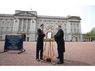 Members of the British Royal household place a bulletin announcing that Catherine, Duchess of Cambridge, Prince William's wife, has given birth to a baby girl, on an easel on the forecourt of Buckingham Palace in London on May 2, 2015. Prince William's wife Kate gave birth to a girl on Saturday, sparking celebrations for the royal couple's new arrival, a princess who becomes the fourth in line to the British throne.