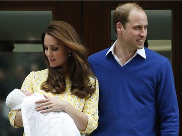 Britain's Prince William, right, and Kate, Duchess of Cambridge, pose for the media with their newborn daughter outside St. Mary's Hospital's exclusive Lindo Wing, London, Saturday, May 2, 2015. The Duchess gave birth to the Princess on Saturday morning.