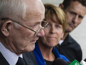 Bryan Casey's father, Gus Casey, left, and wife, LeeEllen Carroll, centre speak outside the Ottawa Courthouse after Ontario Court Justice Neil Kozloff found Pembroke dentist, Christy Natsis guilty of impaired driving causing death and dangerous driving causing death in a 2011 highway crash that killed Bryan Casey.