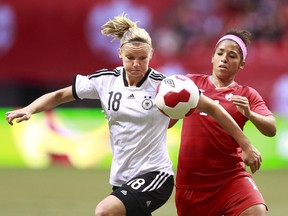 Alexandra Popp of Germany and Desiree Scott of Canada battle for a loose ball during a Women's international friendly game at B.C. Place a year ago. Germany won 2-1.
