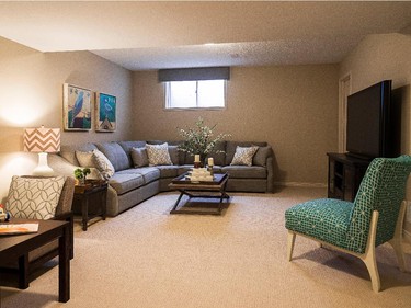 The basement TV room in the Tahoe is furnished with a corner couch that has room for the whole family.