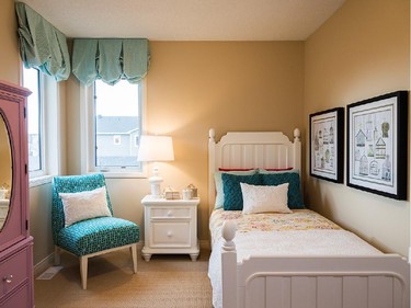 The smallest bedroom in the Tahoe, with pretty turquoise accents, has the charm of two corner windows that look out over the rear yard and garage.