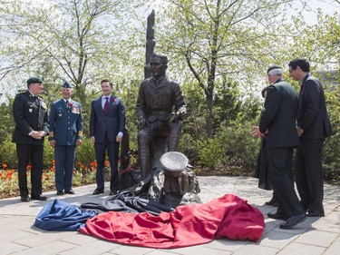 Colonel James Selbie (left) Colonel Pierre Morsset (centre) and Minister Pierre Poilievre (right) as hundred of people were on hand for the unveiling of a new statue commemorating John McCrae, May 3, 2015.