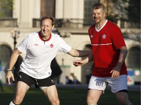 Conservative MP Peter Mackay, left, puts a hand on the National Post's John Ivison.