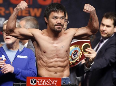 Manny Pacquiao gestures while standing on the scale for the weigh-in on May 1, 2015 in Las Vegas, Nevada one day before their "Fight of the Century" on May 2 at the MGM Grand Garden Arena.