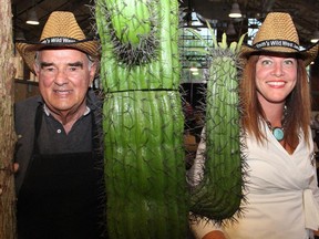 Dave Smith, founder and honourary chair of the Dave Smith Youth Treatment Centre, and Trista Lynch-Black, manager of marketing and community relations for lead sponsor TD Canada Trust, cosy up to the cactus at the Wild West Jamboree held Thursday, May 21, 2015, at the Horticulture Building.