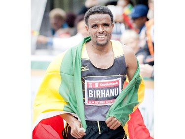 Ethiopia's Girmay Birhanu celebrates his marathon win at Tamarack Ottawa Race Weekend, Sunday, May 24, 2015.