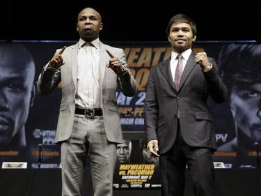 FILE - In this March 11, 2015, file photo, boxers Floyd Mayweather Jr., left, and Manny Pacquiao, of the Philippines, pose for photos after a news conference in Los Angeles. This is not Hagler-Hearns or Tyson vs. Anyone. Floyd Mayweather Jr. is the greatest defensive boxer in history, and Manny Pacquiao hasn't shown knockout power in a while. Expect this fight to go to the scorecards.