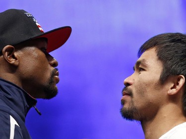 Floyd Mayweather Jr., left, and Manny Pacquiao pose during their weigh-in on Friday, May 1, 2015 in Las Vegas. The world weltherweight title fight between Mayweather Jr. and Pacquiao is scheduled for May 2.