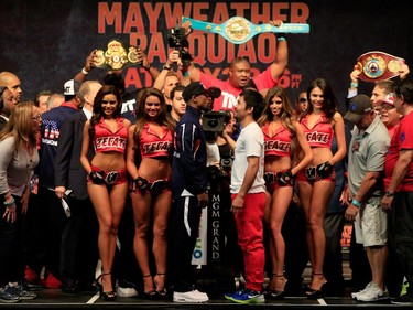 Floyd Mayweather Jr. (L) and Manny Pacquiao face off during their official weigh-in on May 1, 2015 at MGM Grand Garden Arena in Las Vegas, Nevada. The two will face each other in a welterweight unification bout on May 2, 2015 in Las Vegas.