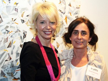 From left, Ottawa Art Gallery director and CEO Alexandra Badzak with artist Sarah Rooney (behind them is a mix media piece by Elaine Saheurs) at the OAG's annual Le pARTy art auction fundraiser, held Thursday, May 21, 2015.