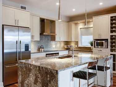 The surprising spacious Quail bungalow features an upgraded waterfall granite island in the kitchen.