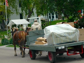 An impractical horse-drawn couch delivery happening on Mackinac Island.