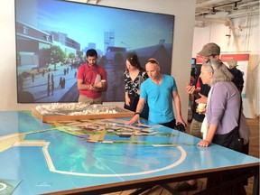 Visitors check out the site plan for Zibi's massive project on the old Domtar lands during an information session in May.