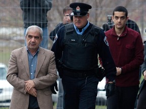 Mohammad Shafia, left, Hamed Shafia and Tooba Mohammad Yahya leave the holding cell at the Frontenac county courthouse in Kingston, Ontario on Tuesday Dec. 13, 2011.