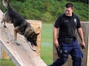 In this undated photo released by the Hattiesburg Police Department, Officer Benjamin Deen participates in K-9 training at the police academy in Hattiesburg, Miss. Officer Deen and Officer Liquori Tate were fatally shot during a traffic stop, Saturday evening, May 9, 2015, in the southern Mississippi city of Hattiesburg, prompting a statewide manhunt early Sunday for two suspects, authorities said. (Hattiesburg Police Department via AP)