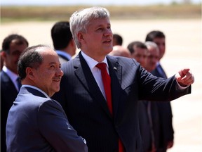 Iraqi Kurdish leader Massud Barzani, left, greets Canadian Prime Minister Stephen Harper upon the latter's arrival in Arbil, the capital of the autonomous Kurdish region of northern Iraq, on May 2, 2015.