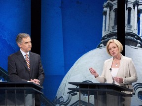 Alberta Progressive Conservative leader Jim Prentice listens to NDP leader Rachel Notley speak during the leaders debate in Edmonton on Thursday April 23, 2015.