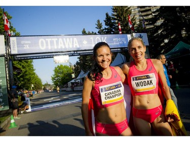 Lanni Marchant poses with fellow Canadian runner Natasha Wodak, right, at the 10K finish line.