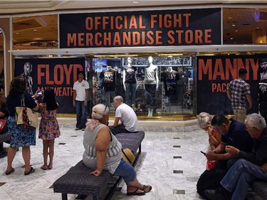 Guests appear outside a store in the lobby of MGM Grand Hotel & Casino selling merchandise for the upcoming fight between WBC/WBA welterweight champion Floyd Mayweather Jr. and WBO welterweight champion Manny Pacquiao on April 29, 2015 in Las Vegas, Nevada. The two boxers will face each other in a unification bout on May 2, 2015 in Las Vegas.