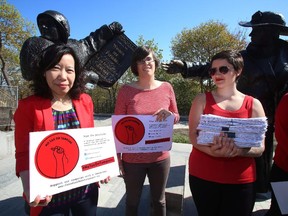 Lele Truong, Lareen Jervis and Mariana Hollmann (left to right) take part in a news conference and petition on Parliament Hill in Ottawa Thursday, May 7, 2015 calling on the federal government to remove tax on feminine hygiene products.
