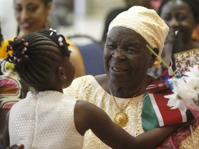 Lizzy Atieno, 5, hugs 'Granny Obama', Sarah Obama, third wife of the U.S. president's paternal grandfather, at Rideau Park United Church on Sunday.