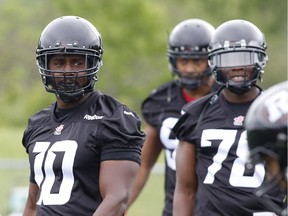 Malik Jackson, left, seen at Redblacks camp at Carleton University on Sunday, May 31, 2015, said 'actually having to go to work every day' in the real world gave him the hunger to play pro football again.