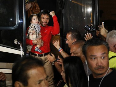 Boxer Manny Pacquiao, of the Philippines, holds his youngest child, Israel, as they arrive at the Delano Las Vegas hotel Monday, April 27, 2015, in Las Vegas. Pacquiao is scheduled to fight Floyd Mayweather Jr. in a welterweight boxing match in Las Vegas Saturday.