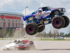 Mike Vaters drives his monster truck over a pair of cars outside The Canadian Tire Centre on May 27, 2015. On May 30 The Canadian Tire Centre will host Monster Spectacular. The show will include monster trucks, freestyle motocross and a speed bike stunt performance.