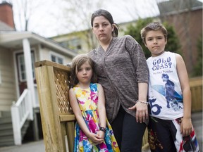 Millissa Ryan and her two children Cody and Isabel are now with out house to call home after their house caught fire over the weekend. Millissa Ryan and her two children Codey and Izabel pose for a portrait in Ottawa, May 4, 2015.