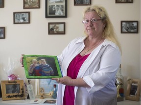 Victoria Lebasseur holds a photo of her daughter, Amanda Trottier.