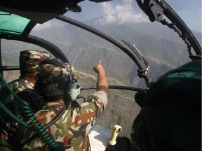 Nepalese army men search for the missing U.S. Marine helicopter in the earthquake affected Dolakha District, Nepal, Thursday, May 14, 2015. The helicopter carrying six Marines and two Nepalese soldiers disappeared Tuesday while delivering aid in the country's northeast, U.S. officials said.