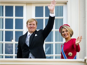 TO GO WITH AFP STORY BY NICOLAS DELAUNAY (FILES) - A file picture taken September 16, 2014 in The Hague during Prinsjesdag, the opening-day of Dutch parliament shows King Willem-Alexander and Queen Maxima waving from Palace Noordeinde. A decision to drag a Dutch activist before a judge on May 6, 2015 for insulting King Willem-Alexander has sparked outrage in liberal-minded Netherlands and prompted prosecutors to re-evaluate the case based on a century-old law. Abulkasim al-Jaberi was arrested in November when television cameras showed him spouting a stream of profanity aimed at the king, Queen Maxima and the royal house.