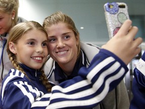 Norwegian soccer player Maren Mjelde poses for a "selfie" with Monika Basset, 12, as the Norwegian soccer team arrives in Ottawa for the Women's FIFA World Cup at Macdonald-Cartier Airport on Sunday, May 31, 2015.