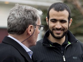 Omar Khadr, right, smiles at his lawyer Dennis Edney, left, as they speak to the media outside his new home after being granted bail in Edmonton on Thursday, May 7, 2015.
