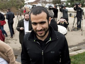 Omar Khadr walks back to his home after speaking to the media after being granted bail in Edmonton on Thursday, May 7, 2015.