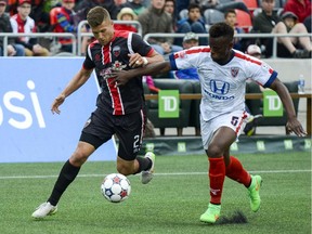 Ottawa Fury FC player Ryan Richter runs for the ball against Indy Eleven player Erik Norales at TD Place on Saturday, May 23, 2015.