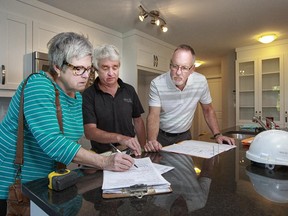 For buyers Janice and Dan Kennedy, the pre-delivery inspection includes lots of paperwork with Brigil’s Gord Pickup, centre.