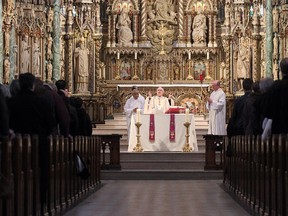 In this 2013 photo, Archbishop Terrence Prendergast holds a midday mass at Notre Dame Basilica in downtown Ottawa.