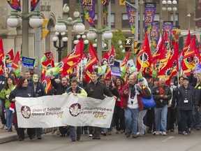 PSAC marches up Wellington to the Prime Ministers office in the Langevin block as part of May Day protests.
