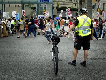 Ottawa police were on hand, helping direct traffic and make sure the protesters stayed peaceful as they voiced their opinions on the government's proposed anti-terrorism legislation, Bill C-51, Saturday, May 30, 2015.