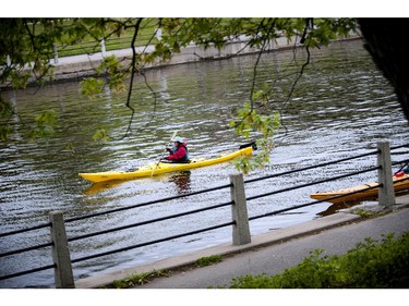 Paddlers check out some of the runners at Tamarack Ottawa Race Weekend from the canal Saturday May 23, 2015.