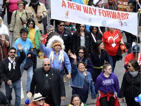 Assembly of First Nations Chief Perry Bellegarde (in headdress) and Justice Murray Sinclair (in black suit), TRC commissioner, march during the Walk for Reconciliation on Sunday, May 31, 2015 in Gatineau.